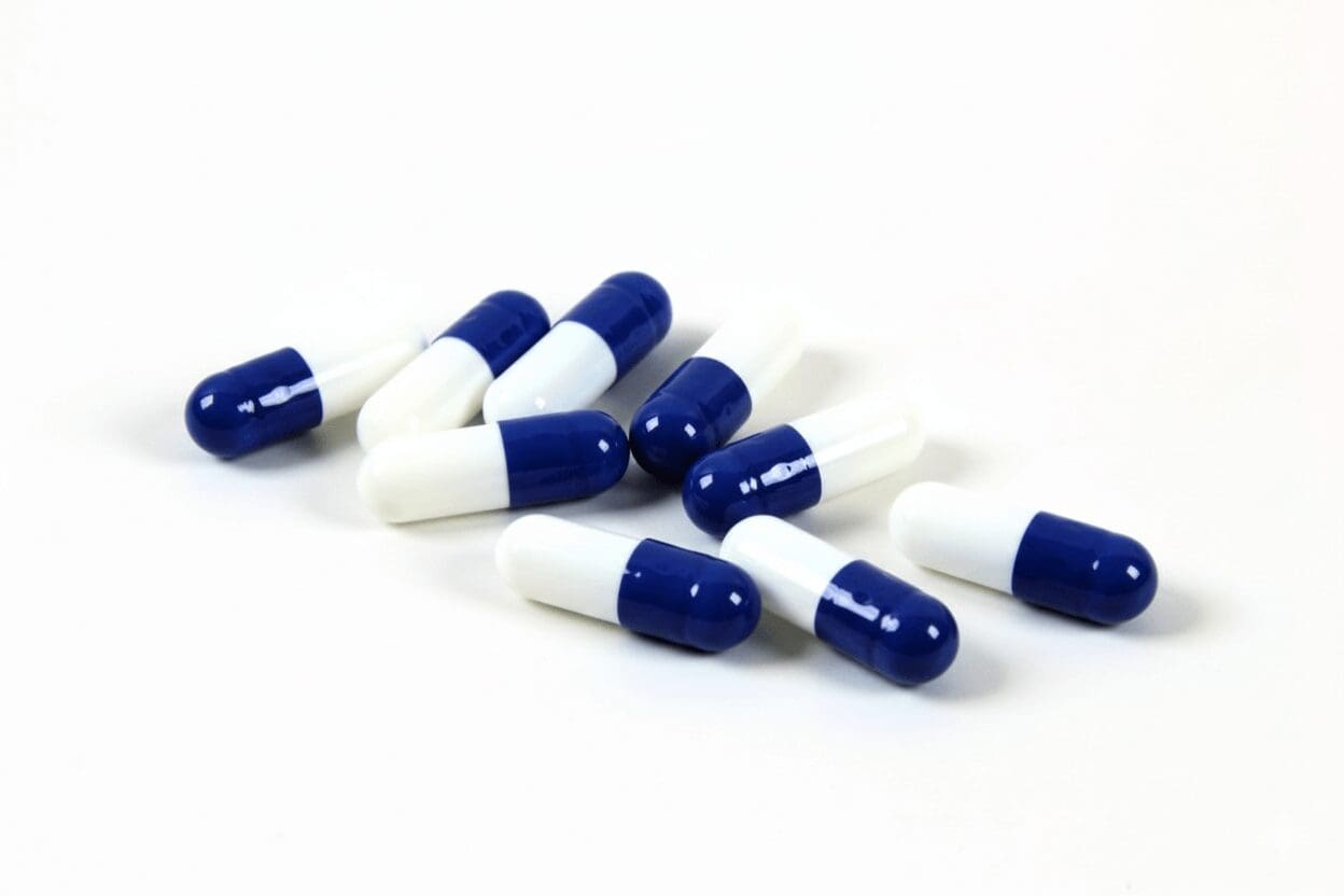 Close-up of glossy blue and white capsules